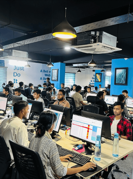 Modern office workspace with team members working at computers