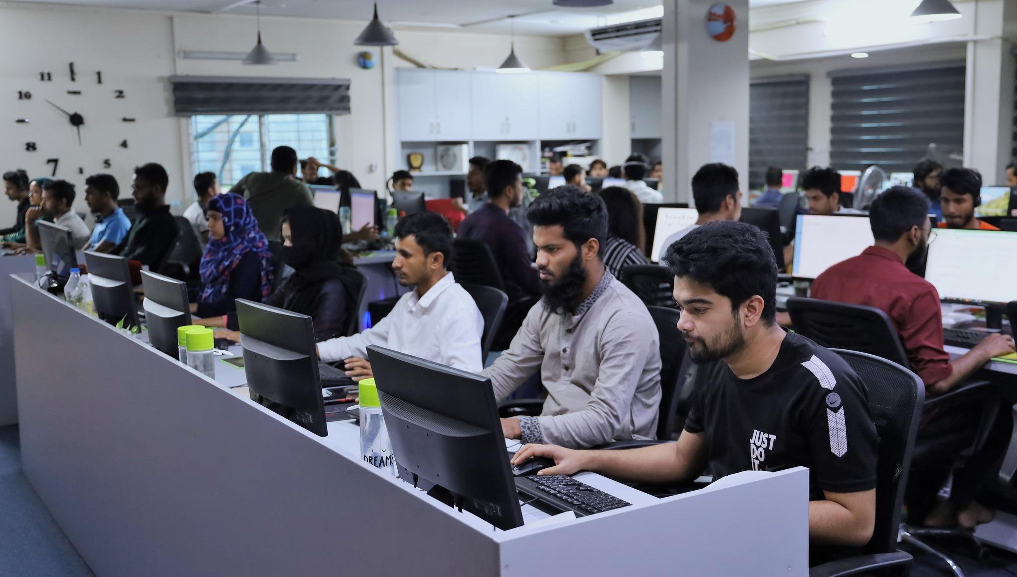 Employees working on global tech projects